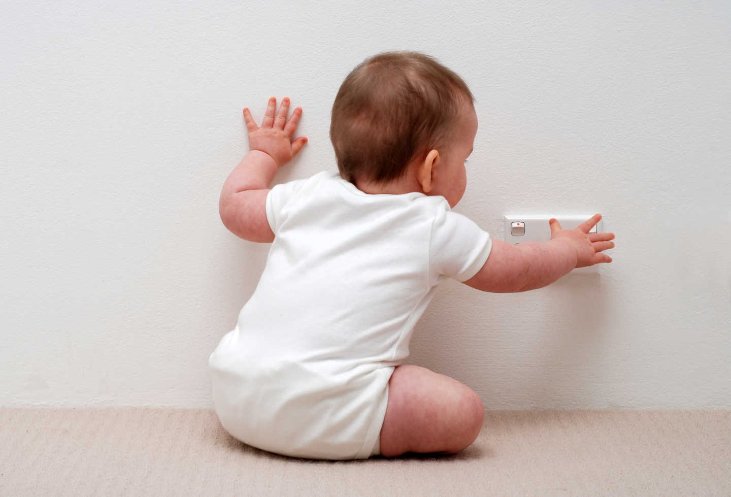 Baby reaching for plug